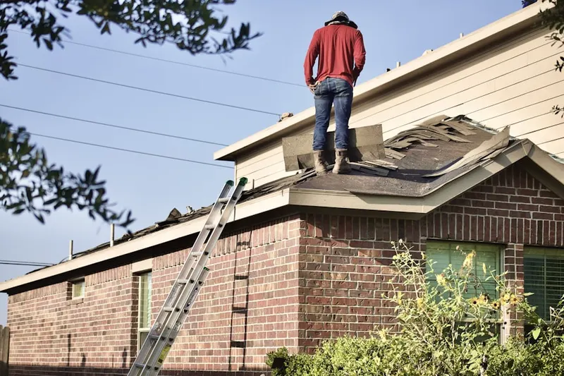 Professional roofer working on a residential roof in Spoolsville